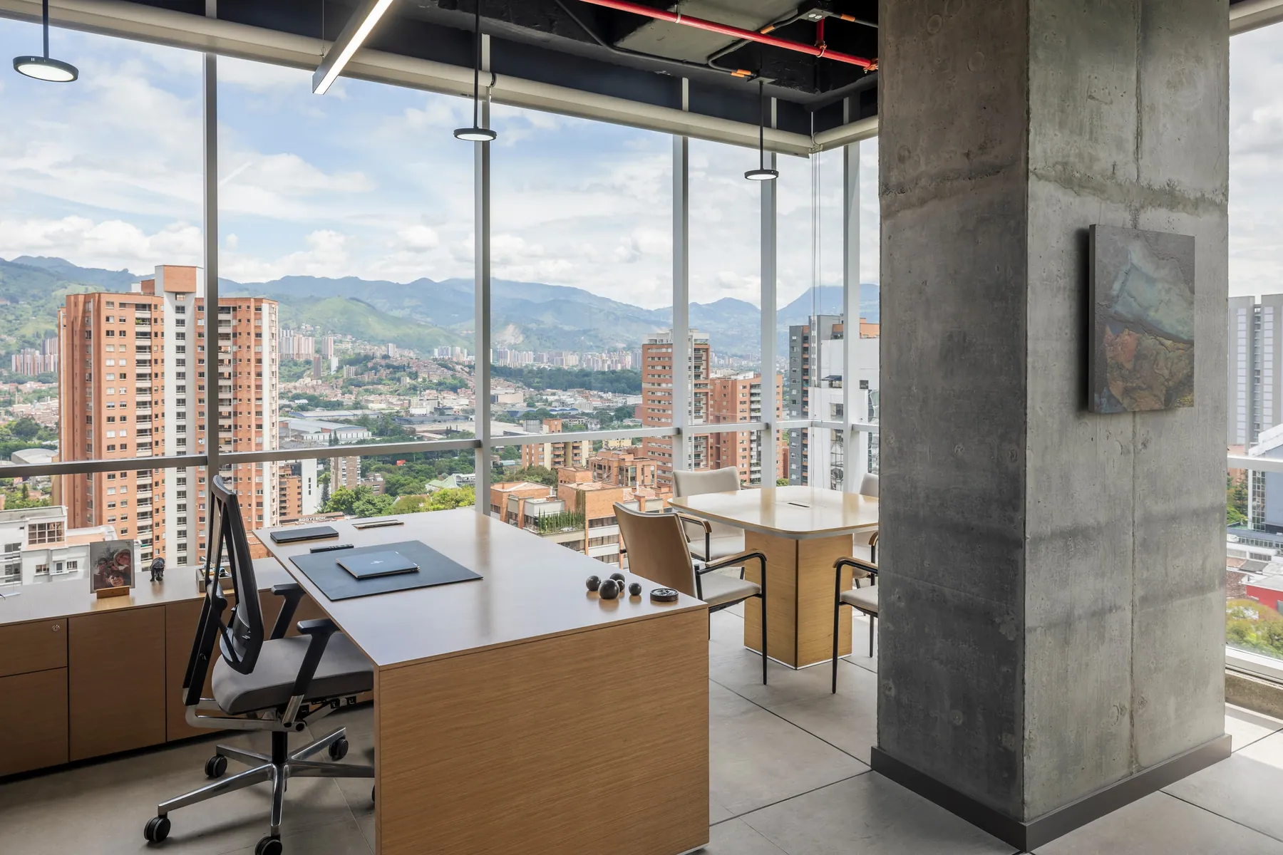 Despacho con columna de concreto a la vista y obra de arte, CrearCimientos